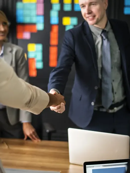 business-people-shaking-hands-meeting-room